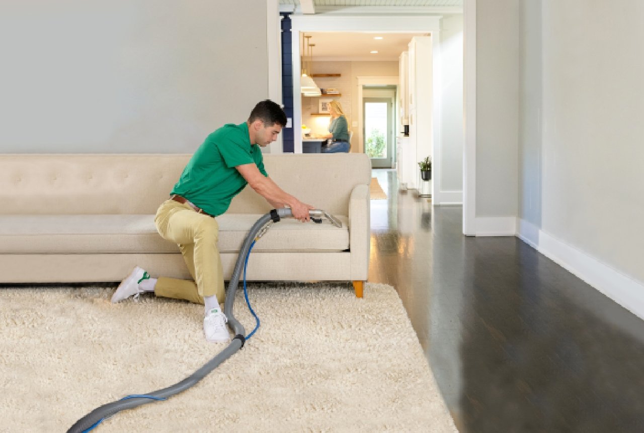 Chem-Dry technician cleaning a fabric sofa with professional upholstery cleaning equipment