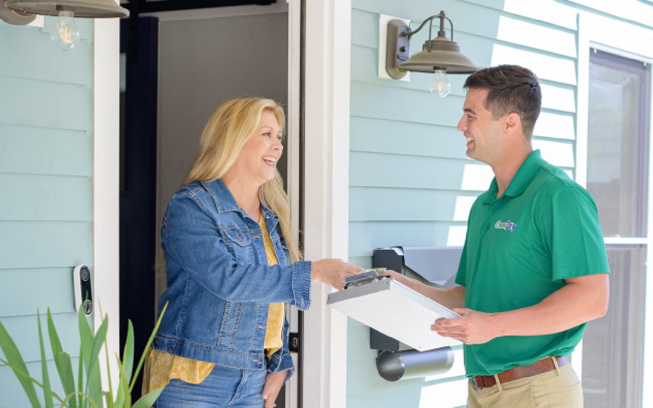 Chem-Dry technician speaking with a customer at her home after a professional cleaning service